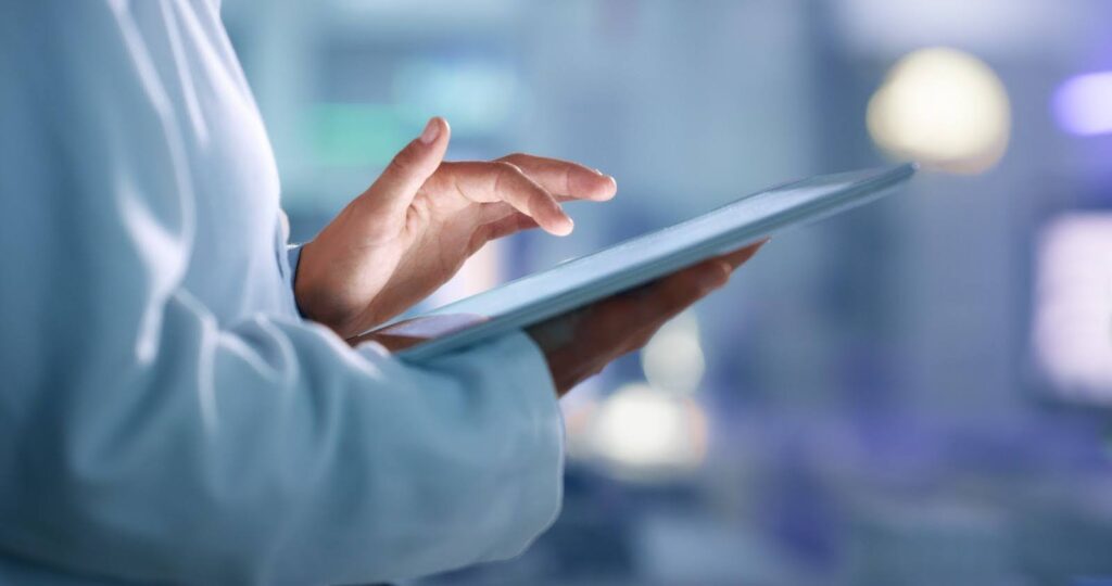 A health informatics professional uses a tablet.